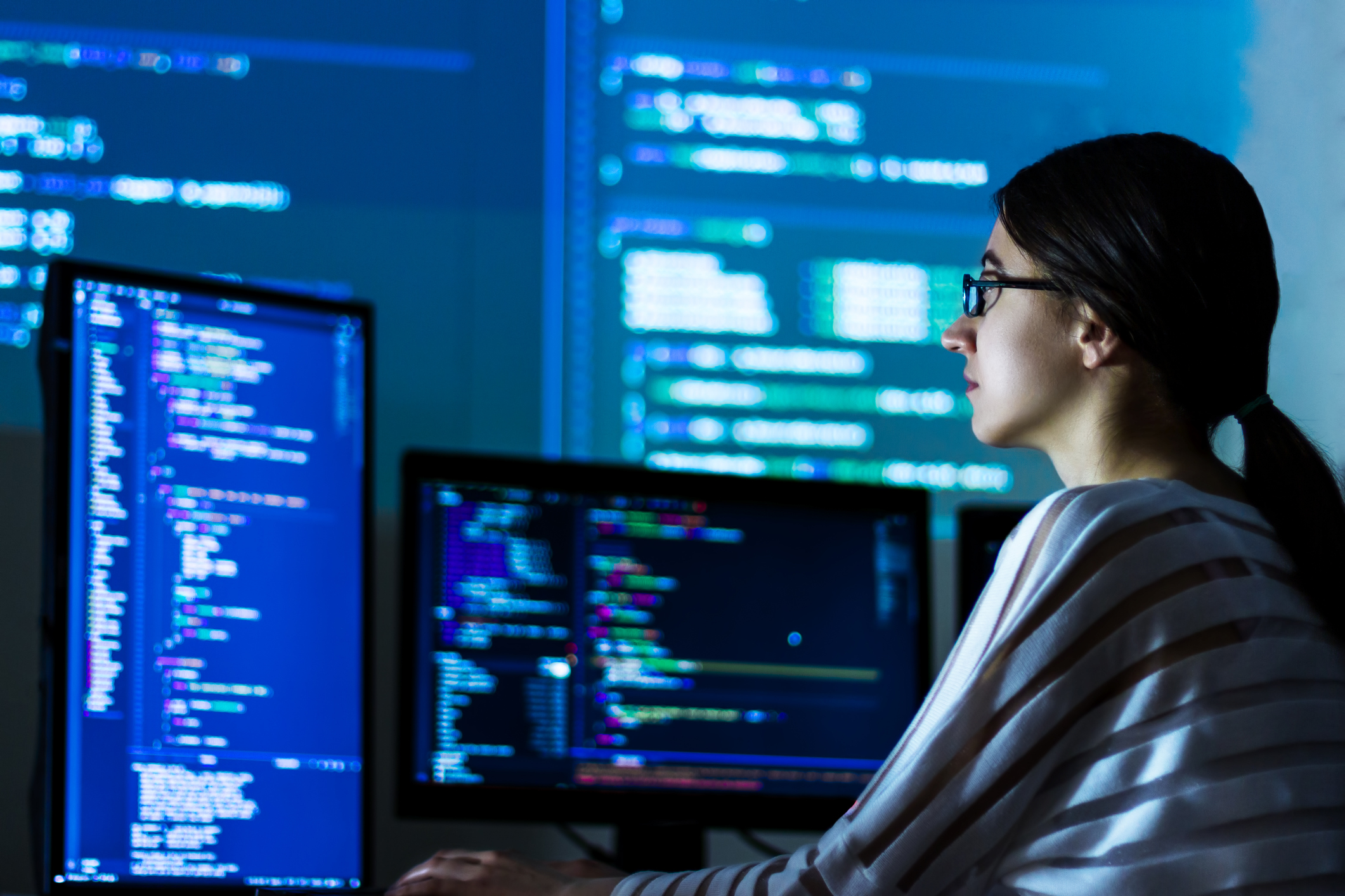 Female engineer looking at data on screen