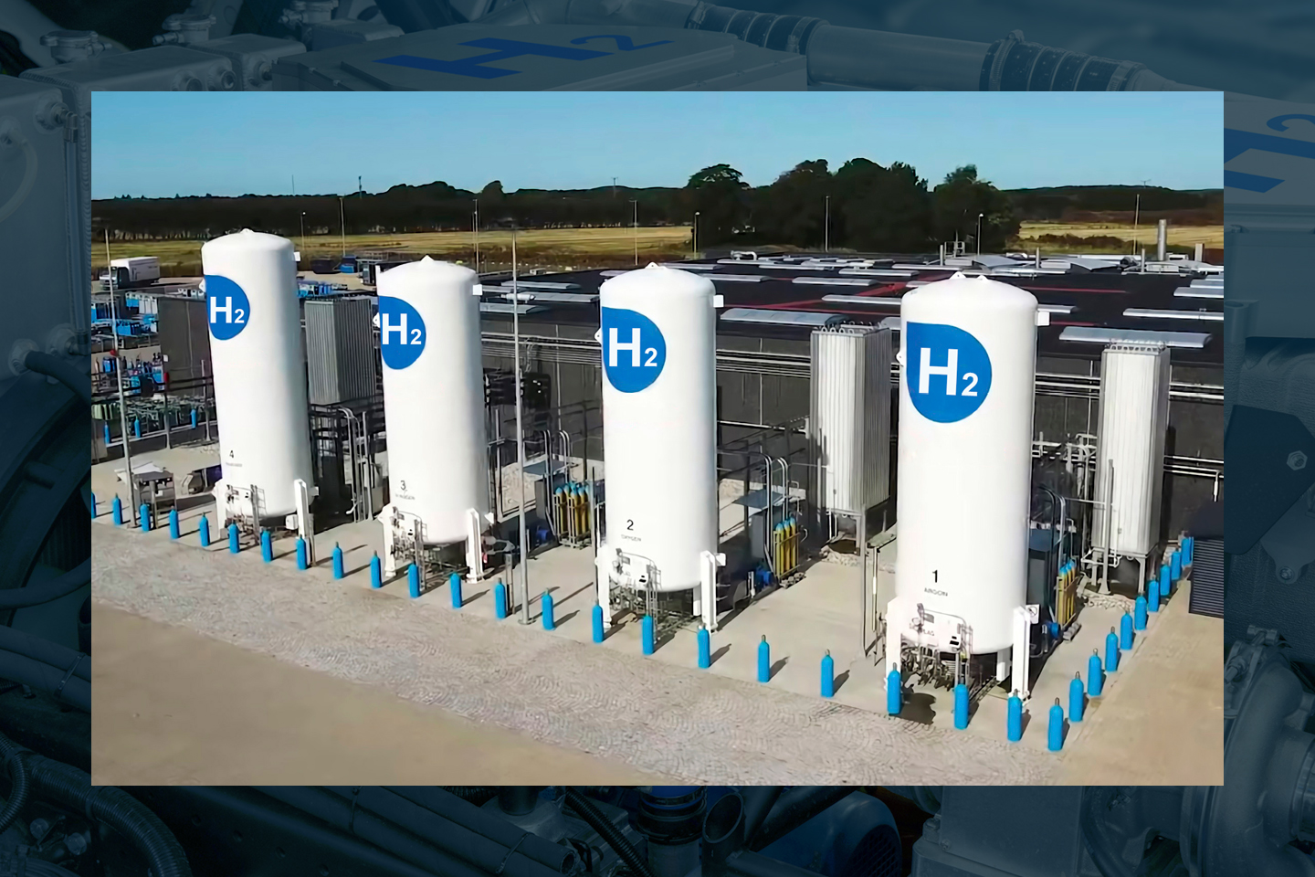 Aerial view of four tanks with blue hydrogen signs on the outside